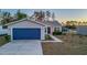 House exterior featuring a blue garage door and walkway at 386 Marion Oaks Trl, Ocala, FL 34473