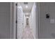 Long hallway with light wood-look floors and access to other rooms at 386 Marion Oaks Trl, Ocala, FL 34473