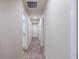 Long hallway with wood-look floors and access to rooms at 386 Marion Oaks Trl, Ocala, FL 34473