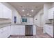 Modern kitchen with white cabinets, granite countertops, and stainless steel appliances at 386 Marion Oaks Trl, Ocala, FL 34473
