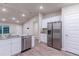 Stainless steel appliances and white cabinetry in this kitchen at 386 Marion Oaks Trl, Ocala, FL 34473