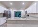 Modern kitchen with white cabinets, granite countertops, and stainless steel appliances at 386 Marion Oaks Trl, Ocala, FL 34473
