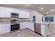 Modern kitchen with stainless steel appliances and granite countertops at 386 Marion Oaks Trl, Ocala, FL 34473