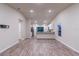 Open living room with kitchen and island, vaulted ceiling, and wood-look flooring at 386 Marion Oaks Trl, Ocala, FL 34473