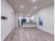 Open living room with kitchen and island, vaulted ceiling, and wood-look flooring at 386 Marion Oaks Trl, Ocala, FL 34473