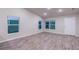 Bright living room with wood-look flooring and large windows at 386 Marion Oaks Trl, Ocala, FL 34473