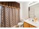 This bathroom features a vanity with sink, toilet, and a patterned shower curtain at 4000 San Gallo Dr # 102, Kissimmee, FL 34741