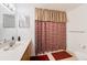This bathroom features a vanity with a mirror, complemented by a stylish patterned shower curtain at 4000 San Gallo Dr # 102, Kissimmee, FL 34741