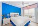 Bright bedroom features a comfortable bed, window with valance and a calming blue accent wall at 4000 San Gallo Dr # 102, Kissimmee, FL 34741