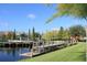 Scenic view of the community dock extending into the water, surrounded by lush greenery and townhomes at 4000 San Gallo Dr # 102, Kissimmee, FL 34741