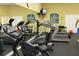 Community fitness center with treadmills, stationary bikes, weights, and fitness rules posted at 4000 San Gallo Dr # 102, Kissimmee, FL 34741