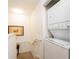 Hallway laundry area features stacked washer and dryer, maximizing space and convenience at 4000 San Gallo Dr # 102, Kissimmee, FL 34741