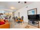 Open-concept living room with adjacent kitchen, dining table, comfortable seating, and natural light at 4000 San Gallo Dr # 102, Kissimmee, FL 34741