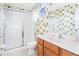 Clean bathroom with shower, toilet and a fun polka dot backsplash at 4525 Stella St, Kissimmee, FL 34746