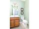 Small half bathroom with light green wallpaper and wood vanity at 4525 Stella St, Kissimmee, FL 34746