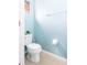 Small half bathroom with toilet and light blue walls at 4525 Stella St, Kissimmee, FL 34746
