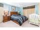 Bedroom with a double bed, nightstands and crib at 4525 Stella St, Kissimmee, FL 34746