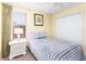 Well-lit bedroom with a twin bed and double door closet at 4525 Stella St, Kissimmee, FL 34746