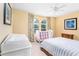 Bedroom with a crib, changing table, and striped bedding at 4525 Stella St, Kissimmee, FL 34746