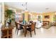 Dining area with a wood table and four chairs, adjacent to living room at 4525 Stella St, Kissimmee, FL 34746