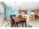 Bright dining room with wood table, chairs, and kitchen views at 4525 Stella St, Kissimmee, FL 34746