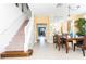 Dining room with a wooden table, chairs, and a view into the kitchen at 4525 Stella St, Kissimmee, FL 34746