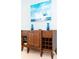 Dark wood entry table with wine rack, blue glass vases, and storage at 4525 Stella St, Kissimmee, FL 34746