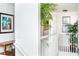 Upstairs hallway with white railing and artwork at 4525 Stella St, Kissimmee, FL 34746