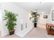 Upstairs hallway with white railing and potted plants at 4525 Stella St, Kissimmee, FL 34746