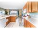Kitchen with light wood cabinets, white appliances, and a breakfast bar at 4525 Stella St, Kissimmee, FL 34746