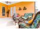 Relaxing wicker patio furniture on a bright orange lanai at 4525 Stella St, Kissimmee, FL 34746