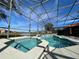 Screened-in pool and spa area with a view of a lake and community at 4525 Stella St, Kissimmee, FL 34746