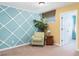 Cozy sitting area with an accent wall and comfortable armchair at 4525 Stella St, Kissimmee, FL 34746