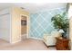Small sitting area with teal accent wall and comfortable chair at 4525 Stella St, Kissimmee, FL 34746