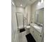 Well-lit bathroom featuring a walk-in shower and modern vanity with ample storage at 4976 Windermere Ave, Kissimmee, FL 34746