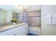 Clean bathroom with double sinks, tub, and shower at 4976 Windermere Ave, Kissimmee, FL 34746