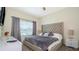 Spacious bedroom with king-size bed and tufted headboard at 4976 Windermere Ave, Kissimmee, FL 34746