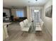 Elegant dining room with a glass-top table and comfortable white chairs, perfect for entertaining guests at 4976 Windermere Ave, Kissimmee, FL 34746