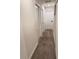 Long hallway with neutral carpet and white doors, illuminated by recessed lighting at 4976 Windermere Ave, Kissimmee, FL 34746