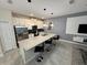 Spacious kitchen boasts stainless steel appliances, a large island, and stylish pendant lighting at 4976 Windermere Ave, Kissimmee, FL 34746