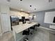Bright and airy kitchen featuring stainless appliances and a large center island with bar seating at 4976 Windermere Ave, Kissimmee, FL 34746