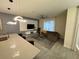 Open-concept living room featuring a modern entertainment center and a comfortable sectional sofa at 4976 Windermere Ave, Kissimmee, FL 34746