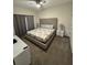 Comfortable main bedroom with a tufted headboard and neutral decor at 4976 Windermere Ave, Kissimmee, FL 34746