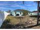 Fenced backyard with a patio and grassy area at 509 Drayton Rd, Winter Haven, FL 33884