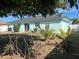 Light teal house with a backyard featuring landscaping and a patio at 509 Drayton Rd, Winter Haven, FL 33884