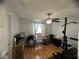 Bright home office features hardwood floors, a desk, and exercise equipment at 509 Drayton Rd, Winter Haven, FL 33884