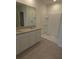 Bathroom with double vanity, granite countertop, and a shower at 522 Noble Ave, Davenport, FL 33837