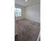 Well-lit bedroom with carpeted floors and a window at 522 Noble Ave, Davenport, FL 33837