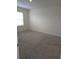 Spacious bedroom featuring carpeted floors and a window with blinds at 522 Noble Ave, Davenport, FL 33837