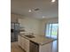 Kitchen island with granite countertop, double sink and stainless steel dishwasher at 522 Noble Ave, Davenport, FL 33837